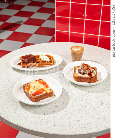 Served table with brunch toasts and waffle 125117358