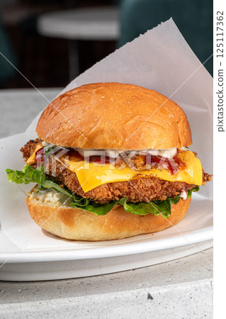 Portion of appetizing fried chicken burger 125117362