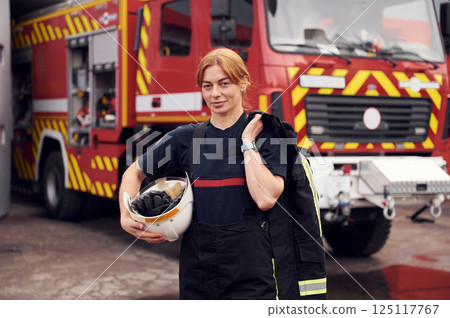 Woman firefighter in uniform is at work in department Woman firefighter in uniform is at work in department 125117767
