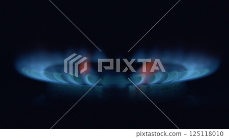 CloseUp View of a Gas Burner Flame in a Dark Environment with Surrounding Features 125118010