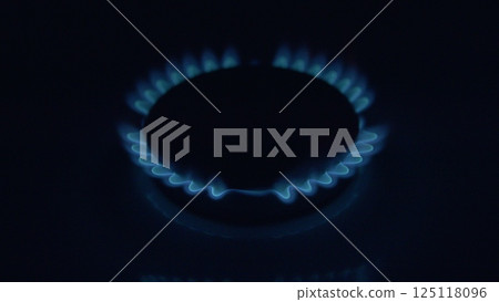 A captivating Embering Gas Flame on a Cooktop, showcasing its dynamic beauty in the kitchen, 125118096
