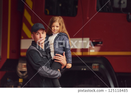 Firefighter man is with little girl at department Firefighter man is with little girl at department 125118485