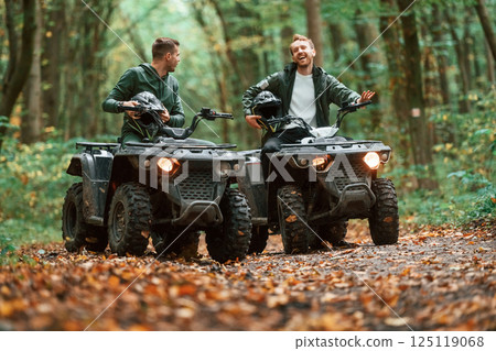 Two male atv riders is in the forest together Two male atv riders is in the forest together 125119068