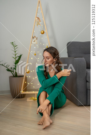 Woman Green Dress Christmas Tree Home Festive Season: Indoor Portrait, December, Cozy Atmosphere 125119312