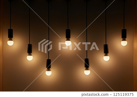 Lightbulbs hanging on wires, soft decoration lighting 125119375