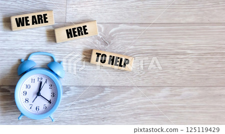 We're here to help, a symbol. Conceptual words that we can write on wooden blocks. We're here to help, a symbol. Conceptual words that we can write on wooden blocks. 125119429
