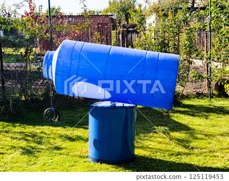 Cleaning of a drinking water container. Blue plastic container for clean water is drying in the sun. 125119453