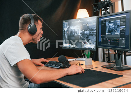 Young man playing and streaming the first person shooter game Young man playing and streaming the first person shooter game 125119654