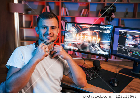 Male game streamer in casual clothes is indoors with pc Male game streamer in casual clothes is indoors with pc 125119665