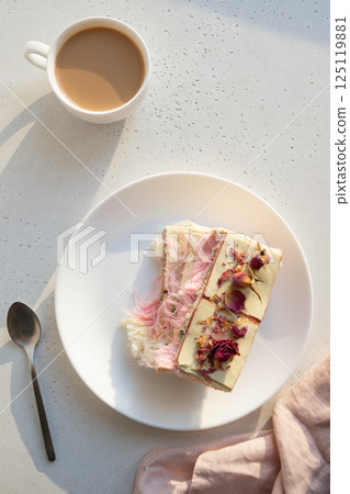 Tasty trendy breakfast with handicraft coffee and pink chocolate with airy filling white and pink pismaniye. Dessert with Cotton candy. Vertical. View from above. Tasty trendy breakfast with handicraft coffee and pink chocolate with airy filling white and pink pismaniye. Dessert with Cotton candy. Vertical. View from above. 125119881