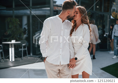 Beautiful young couple together outdoors on the street 125120021
