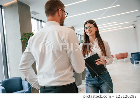 Talking, making a deal. Man and woman in formal clothes are working together indoors 125120282