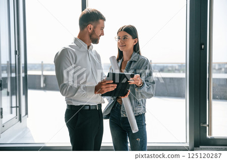 Making a deal. Industry workers are in the building at daytime. Construction location 125120287
