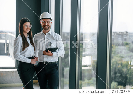 Making a deal. Industry workers are in the building at daytime. Construction location 125120289