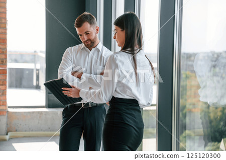 Modern windows. Industry workers are in the building at daytime. Construction location Modern windows. Industry workers are in the building at daytime. Construction location 125120300