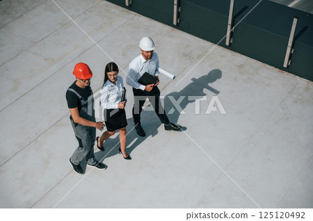 Walking and talking. Top view of men and woman that are on construction site, working together on the project 125120492