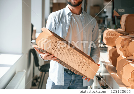 Print house worker in white clothes is indoors Print house worker in white clothes is indoors 125120695