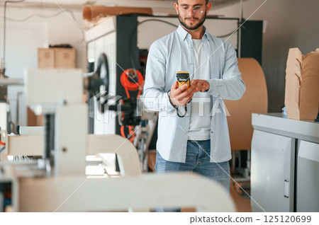 Print house worker in white clothes is indoors Print house worker in white clothes is indoors 125120699
