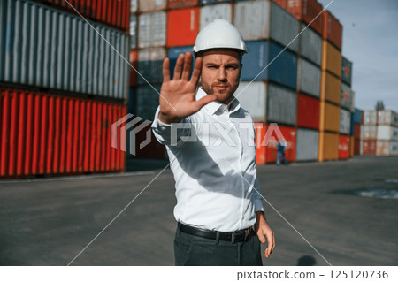 No trespassing. Area is closed. Male worker is on the location with containers No trespassing. Area is closed. Male worker is on the location with containers 125120736