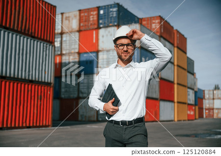 Male worker is on the location with containers 125120884
