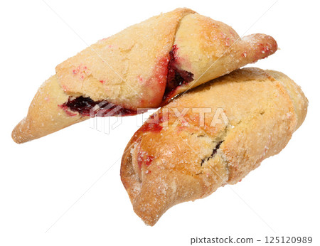 Two cookies filled with raspberry jam and sprinkled with sugar, isolated  background. The pastry is golden brown 125120989