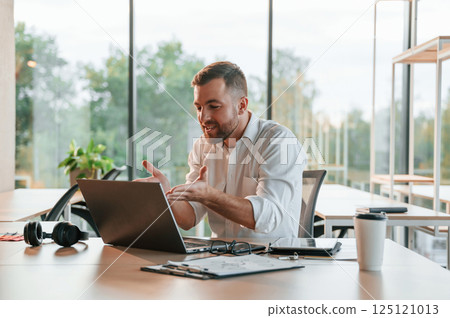 Successful project. Concept of celebration and happiness. Man in formal clothes is working in the modern office Successful project. Concept of celebration and happiness. Man in formal clothes is working in the modern office 125121013