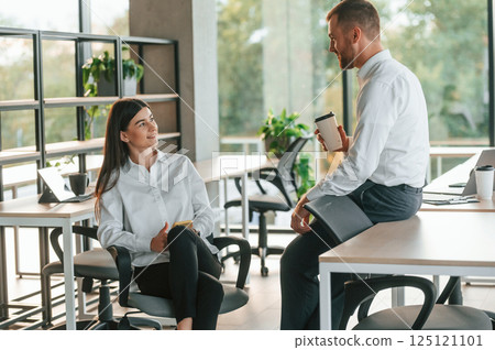 Man and woman are working in the modern office together Man and woman are working in the modern office together 125121101