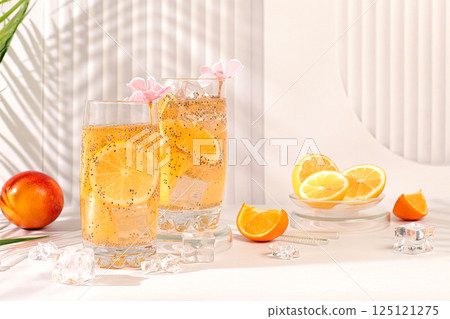 Modern still life with citrus fruits. Diet vegan cocktail with chia seeds, orange, lime, violet and ice. Detox diet and weight loss concept. Summer banner and screen template. Modern still life with citrus fruits. Diet vegan cocktail with chia seeds, orange, lime, violet and ice. Detox diet and weight loss concept. Summer banner and screen template. 125121275