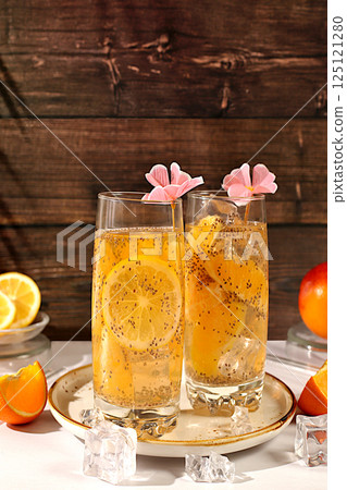 Diet vegan cocktail with chia seeds, orange, lime, violet and ice.Detox diet and weight loss concept. Summer party and healthy lifestyle advertisement. Summer banner and screen template. 125121280