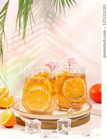 Diet vegan cocktail with chia seeds, orange, lime, violet and ice.Detox diet and weight loss concept. Summer party and healthy lifestyle advertisement. Summer banner and screen template. Diet vegan cocktail with chia seeds, orange, lime, violet and ice.Detox diet and weight loss concept. Summer party and healthy lifestyle advertisement. Summer banner and screen template. 125121283