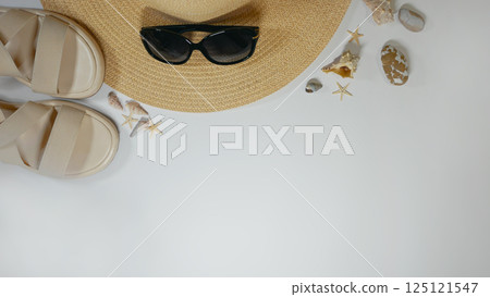 Summer travel vacation mood layout lifestyle spa or wellness concept with beach accessories and copy space. Top view flat lay background, including straw hat, sunglasses, sandals seashells and pebbles Summer travel vacation mood layout lifestyle spa or wellness concept with beach accessories and copy space. Top view flat lay background, including straw hat, sunglasses, sandals seashells and pebbles 125121547