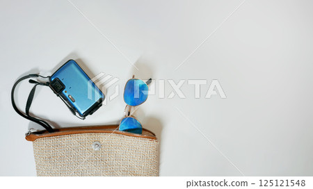 Summer travel vacation mood layout lifestyle spa or wellness concept with beach accessories and copy space. Top view flat lay background, including beach bag, sunglasses, photo camera Summer travel vacation mood layout lifestyle spa or wellness concept with beach accessories and copy space. Top view flat lay background, including beach bag, sunglasses, photo camera 125121548