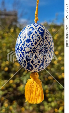 Celebrate traditional Easter with beautiful Ukrainian pysanka featuring intricate patterns and vibrant colors of Easter eggs, showcasing the rich folk art tradition 125121773