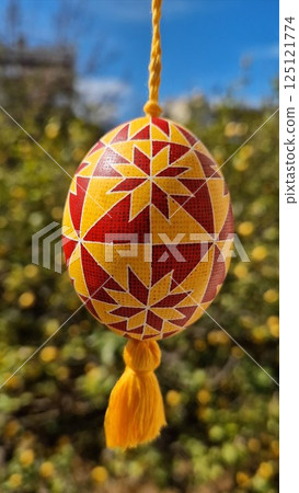 Explore the beauty of Easter eggs through Ukrainian pysanka, featuring intricate traditional patterns and vibrant colors, celebrating the spirit of traditional Easter 125121774