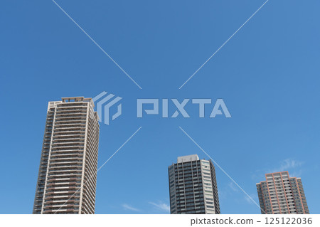High-rise apartment shining in the blue sky 125122036