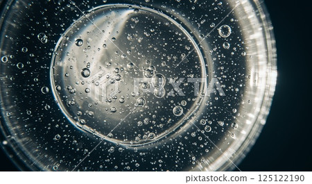 Transparent gel droplet with air bubbles under soft diffused light in extreme close-up 125122190