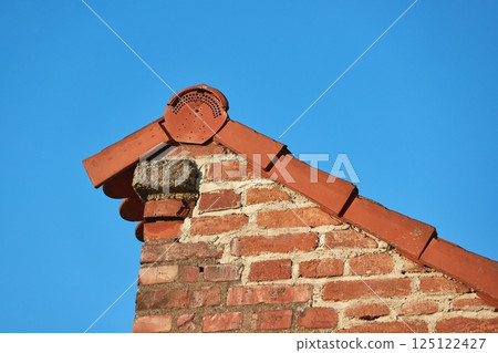 Roof and brick wall detail 125122427