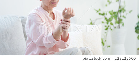 Elderly woman with numb arms 125122500