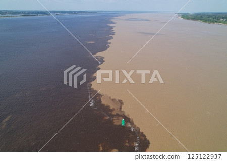Convergence of Rio Negro and Amazon River showcasing distinct water colors 125122937