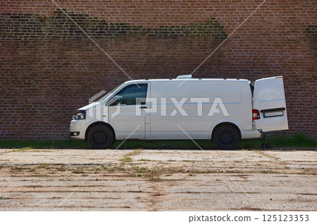 White van in front of a brick wall White van in front of a brick wall 125123353