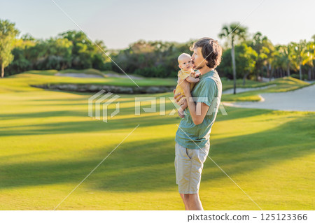 Father and newborn baby on a meadow in the park. Tender moment of bonding and love in nature. Parenthood, fatherhood, and family connection concept 125123366