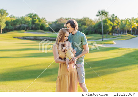 Loving parents with their newborn baby on a meadow in the park. Happy family enjoying nature, bonding, and peaceful outdoor moments. Parenthood, love, and family connection concept Loving parents with their newborn baby on a meadow in the park. Happy family enjoying nature, bonding, and peaceful outdoor moments. Parenthood, love, and family connection concept 125123367