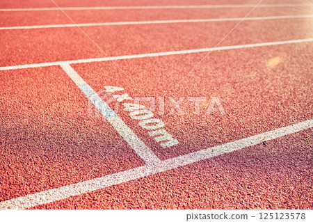 Sport, running track and stadium background for marathon, race and competition or fitness training for track and field athlete. Line, texture and path with nobody on rubber floor for fast run outdoor Sport, running track and stadium background for marathon, race and competition or fitness training for track and field athlete. Line, texture and path with nobody on rubber floor for fast run outdoor 125123578