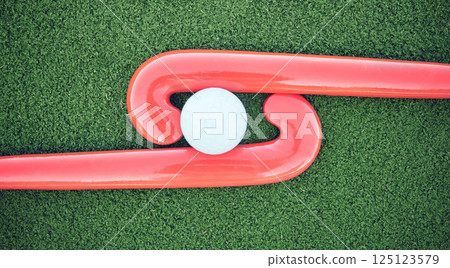 Hockey, ball and stick on green field, pitch and equipment against grass background after game, competition and match. Sports equipment, top view and astroturf with in practice, training and sport Hockey, ball and stick on green field, pitch and equipment against grass background after game, competition and match. Sports equipment, top view and astroturf with in practice, training and sport 125123579