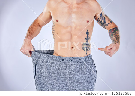 Lose weight, fitness and man stomach, body and muscle results check for diet, workout or exercise wellness goals in studio. Athlete, sports model hand show training success or weight loss progress Lose weight, fitness and man stomach, body and muscle results check for diet, workout or exercise wellness goals in studio. Athlete, sports model hand show training success or weight loss progress 125123593
