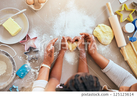 Black woman, child hands or kitchen baking of heart shape pastry, house cookies or dessert biscuit scone in family home. Top view, mother or girl cooking food in help, support or learning cake recipe Black woman, child hands or kitchen baking of heart shape pastry, house cookies or dessert biscuit scone in family home. Top view, mother or girl cooking food in help, support or learning cake recipe 125123614