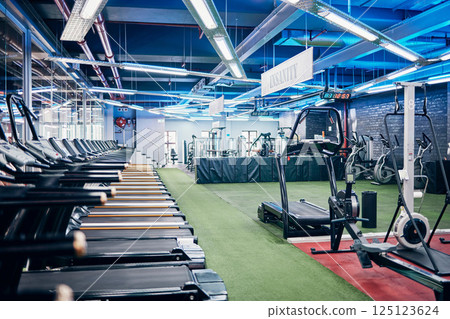 Empty gym, equipment and studio for fitness, exercise and sports or wellness training indoors. Treadmill, machines and health center for workout, athletics and motivation for race or marathon Empty gym, equipment and studio for fitness, exercise and sports or wellness training indoors. Treadmill, machines and health center for workout, athletics and motivation for race or marathon 125123624