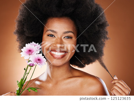 Flower, beauty and hair care of a black woman portrait with skin glow and wellness. Woman model with afro happy about natural, luxury and cosmetic beauty with a smile and flowers for facial treatment 125123635