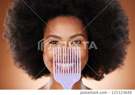 Hair care, comb and black woman with smile, natural beauty and skincare against brown studio background. Cosmetics, beautician and African American woman with afro, combing and happy with portrait. 125123688