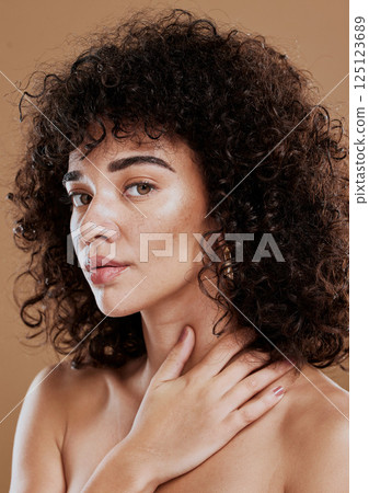 Face, beauty and skincare with a model black woman in studio on a brown background for natural hair care. Eyes, portrait and makeup with an attractive young female posing to promote cosmetics Face, beauty and skincare with a model black woman in studio on a brown background for natural hair care. Eyes, portrait and makeup with an attractive young female posing to promote cosmetics 125123689